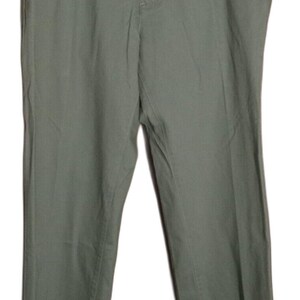 May include: A pair of sage green trousers featuring a standard waistband with belt loops, a central button closure, a zippered fly, and two side pockets. The pants have a straight-leg cut and a smooth, solid-colored fabric construction throughout.