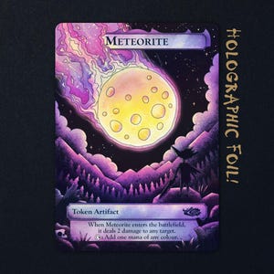 May include: A rectangular game card titled Meteorite featuring a yellow cratered celestial body falling through a purple and pink nebula sky above a dark mountain landscape with a silhouette figure standing in the foreground and text below.