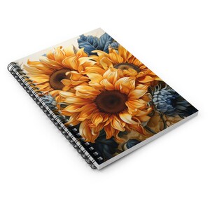 May include: A spiral-bound notebook featuring a vibrant watercolor illustration of sunflowers. The sunflowers have bright yellow petals and dark brown centers, with blue-green foliage. The notebook's design is on a white background.