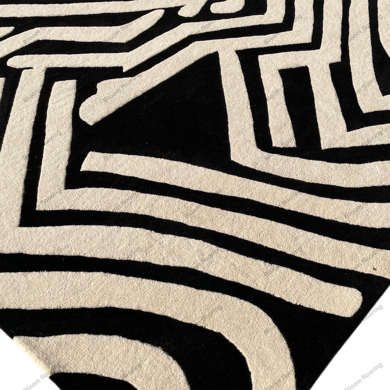 Scandinavian hand-tufted wool rug in black and white geometric pattern, plush minimalist decor for open space living room.