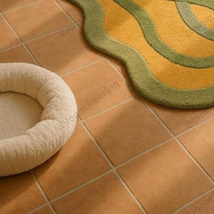 Hand tufted wool rug in mustard and green with abstract geometric loops; vintage-style bohemian area rug in a living room.