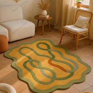 Hand tufted wool rug in mustard and green with abstract geometric loops; vintage-style bohemian area rug in a living room.