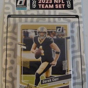 Conjunto de futebol americano Donruss Team 2023 do New Orleans Saints com Derek Carr em embalagem lacrada