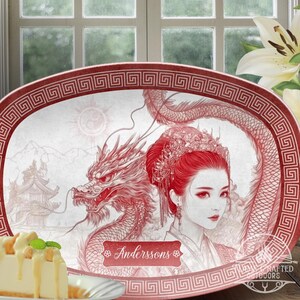 May include: An oval serving platter in red and white with a decorative border. The platter features a detailed illustration of a dragon and a woman in traditional Chinese clothing. The text "Anderssons" is printed on the platter.