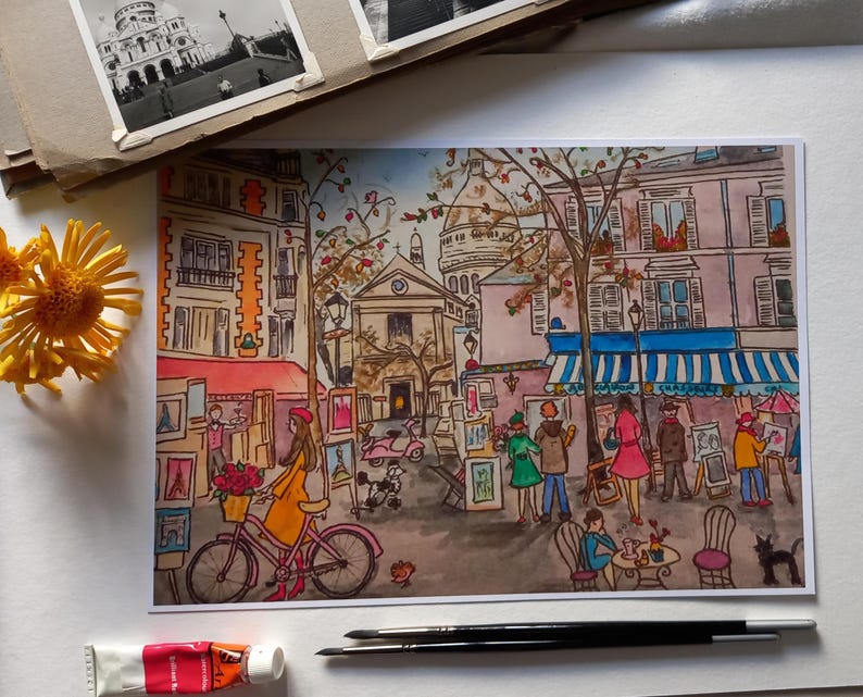 Puede incluir: Una pintura de acuarela de una escena callejera parisina con un caf&eacute;, artistas y una iglesia en el fondo. La pintura est&aacute; hecha en un estilo caprichoso con colores brillantes y l&iacute;neas audaces.
