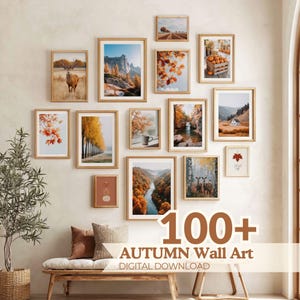 May include: A gallery wall arrangement of fourteen framed prints featuring autumn landscapes, forests, deer, pumpkins, and foliage in light wood frames. The text 100+ AUTUMN Wall Art DIGITAL DOWNLOAD is overlaid in brown at the bottom right.