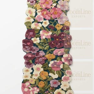 May include: A rectangular floral rug featuring a dark teal base and a pattern of pink, purple, yellow, and white flowers. The rug has a scalloped edge and a dense, textured appearance, possibly hand-tufted or embroidered. The rug's measurements are in centimeters.