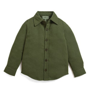 May include: A long-sleeved, green button-down shirt with a collared neckline. The shirt has a textured fabric and is made by the brand "Mini Rodini".