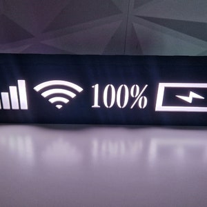 May include: Black wooden sign with white LED lights displaying icons for signal strength, Wi-Fi, battery, and the text "100%".