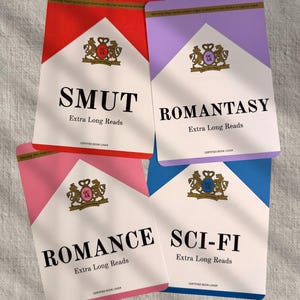 May include: Four colorful cards with text, each resembling a cigarette pack. The cards are red, purple, pink, and blue, with the words "SMUT", "ROMANTASY", "ROMANCE", and "SCI-FI" printed on them. Each card also says "Extra Long Reads".