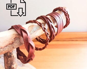 May include: A set of five brown leather bracelets, braided and woven, displayed on a wooden branch. The bracelets are stacked on top of each other, with the largest at the bottom and the smallest at the top.