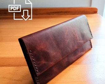 May include: A brown leather wallet with a fold-over closure. The wallet is on a wooden surface.