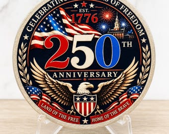 May include: A circular commemorative coin featuring the text CELEBRATING 250 YEARS OF FREEDOM, EST. 1776, 250TH ANNIVERSARY, LAND OF THE FREE, and HOME OF THE BRAVE. The design includes an American flag, fireworks, a building, and a bald eagle.