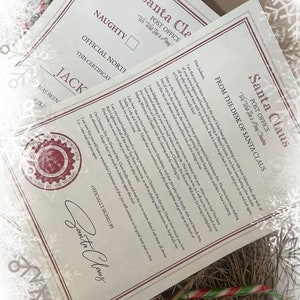 May include: Two official Santa Claus letters, one marked "Naughty" and the other with a letter from Santa. The letters are on cream-colored paper with a red border and text. A candy cane rests below.