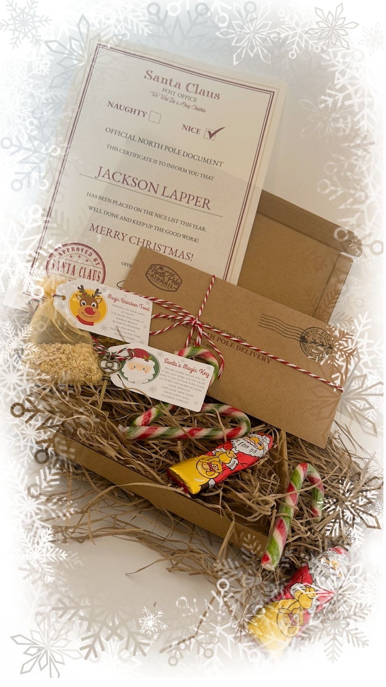 May include: A Christmas-themed gift set with a certificate from Santa Claus, a brown envelope, candy canes, and a chocolate bar. The certificate is addressed to Jackson Lapper and states he is on the nice list. The set includes "Magic Reindeer Food" and "Santa's Magic Key" tags.