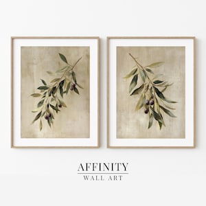 May include: Two framed prints of olive branches with green leaves and purple olives. The artwork has a neutral beige background and is framed in light brown wood. The text "AFFINITY WALL ART" is at the bottom.