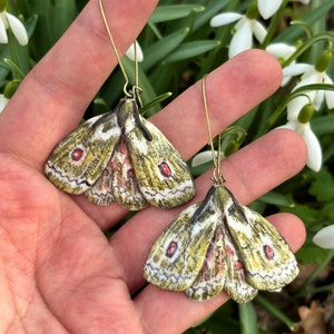 Green porcelain moth dangle earrings.