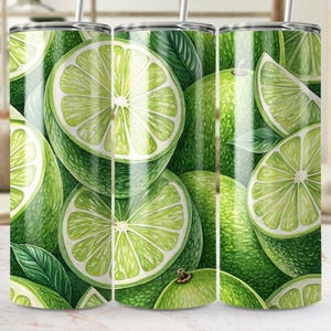 May include: A set of three stainless steel tumblers with a vibrant lime design. The design features whole and sliced limes with green leaves, creating a refreshing and summery aesthetic. Each tumbler includes a straw.