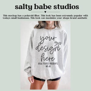 May include: A light gray sweatshirt with the text "your design here" in a script font. The sweatshirt is a mockup, with the words "REAL PEOPLE MOCKUPS NO AI" below the main text. The image also includes the text "salty babe studios".