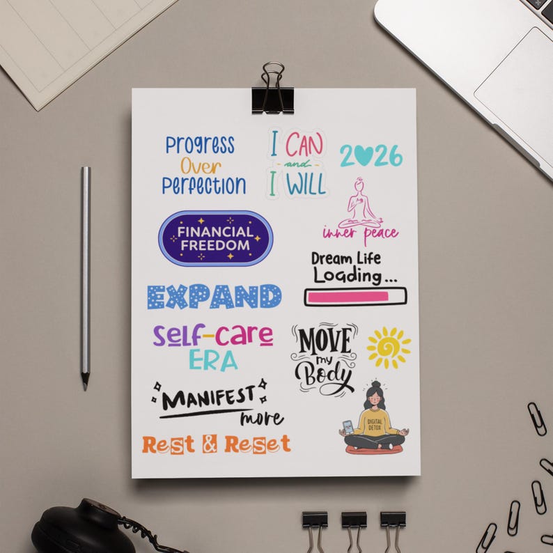 2026 Vision Board Words printable sheet on a blue background with motivational quotes such as Family First, Stay Present, Embrace the Mess, A New Era of Me, Prove Them Wrong, Dream House, and Joy. Includes colorful typography and positive affirmations for goal setting and New Year vision board projects.