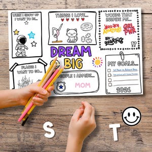 Kids Vision Board 2026 printable activity page being colored with pencils showing Dream Big design, goal setting template with affirmations and goal planning ideas for children. Fun New Year activity for kids vision board craft focused on inspiration, creativity, and positive thinking.