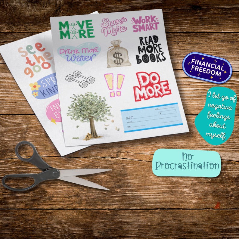 2026 Vision Board Words printable sheets on a wooden table with motivational cutouts including Move More, Save More, Do More, and Financial Freedom. Scissors and positive quote cutouts like No Procrastination and I Let Go of Negative Feelings About Myself are arranged for crafting a vision board or goal planner.