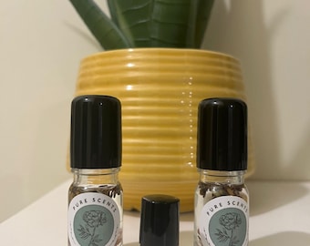 May include: Three glass roller bottles with black caps and white labels. The labels feature a green floral design and the text "PURE SCENTS" and "Calm".