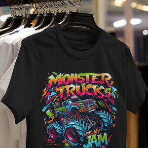 May include: Black t-shirt with a colorful graphic of a monster truck. The text "Monster Trucks Are My Jam" is printed on the shirt.