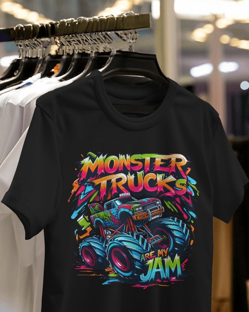May include: Black t-shirt with a colorful graphic of a monster truck. The text "Monster Trucks Are My Jam" is printed on the shirt.