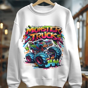 May include: White sweatshirt with a colorful graphic of a monster truck with the text "Monster Trucks Are My Jam".