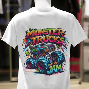 May include: White t-shirt with a colorful graphic of a monster truck with the text "Monster Trucks Are My Jam".