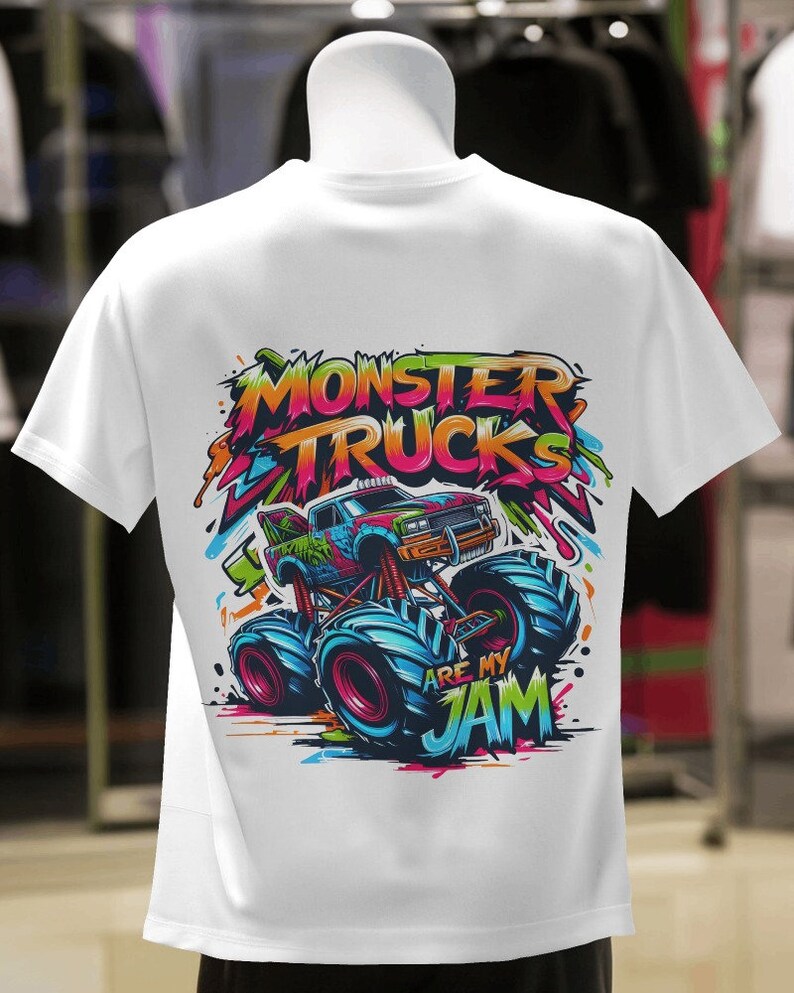 May include: White t-shirt with a colorful graphic of a monster truck with the text "Monster Trucks Are My Jam".