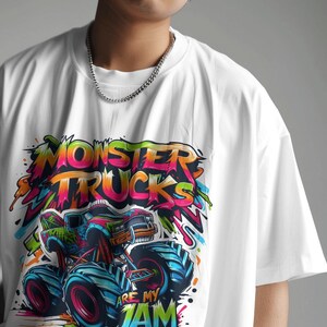 May include: White t-shirt with a colorful graphic of a monster truck. The graphic includes the text "Monster Trucks Are My Jam".
