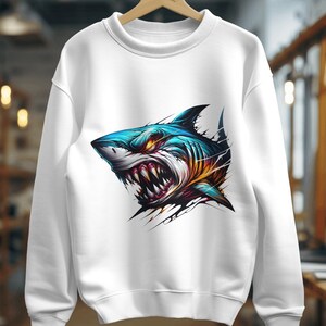May include: White sweatshirt with a colorful graphic of a shark's head with sharp teeth.