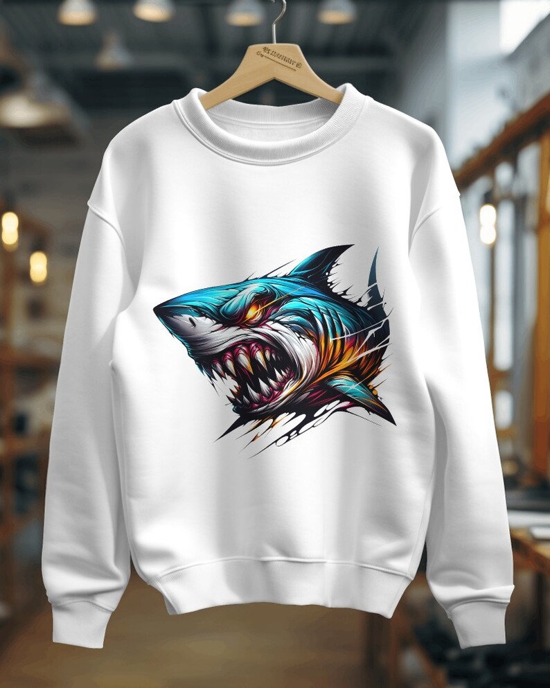 May include: White sweatshirt with a colorful graphic of a shark's head with sharp teeth.