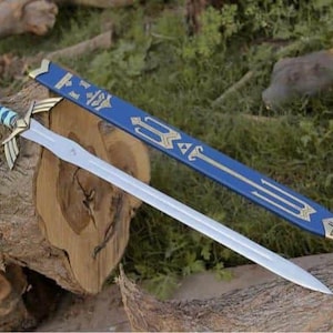 May include: A silver sword with a blue and gold handle and a matching blue sheath. The sword is resting on a wooden log, with grass and other logs in the background. The sword has a detailed design.
