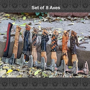 May include: Set of eight axes with wooden handles and intricate metal heads. The axes have different designs and patterns on the heads, including a checkered pattern, a leather wrap, and a design with a knot.