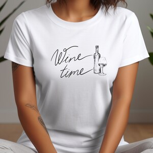 May include: White t-shirt with the text "Wine time" in black script and a black and white illustration of a wine bottle and glass.