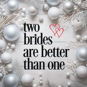 Puede incluir: Un fondo de madera blanco con adornos plateados y ramas blancas. El texto "two brides are better than one" está escrito en negro con dos corazones rojos sobre la palabra "brides".