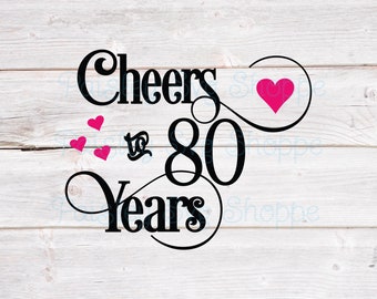 May include: Black and white graphic design with the text "Cheers to 80 Years" and three pink hearts. The design is on a white wood background.