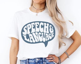 May include: White t-shirt with a blue speech bubble graphic that says "Speech & Language".