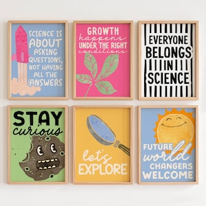May include: Six framed art prints with educational themes. The prints feature colorful backgrounds and text such as "Science is about asking questions" and "Everyone belongs in science." Other prints include a rocket, leaf, cookie, magnifying glass, and smiling sun.