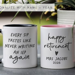 May include: Two white ceramic mugs with black and pink accents. One mug reads "EVERY SIP TASTES LIKE NEVER WRITING AN IEP again." The other says "happy retirement" with a heart, "MRS JACOBS 2026."