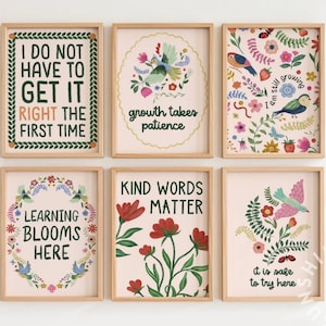 May include: Six framed art prints with inspirational quotes and floral designs. The prints feature phrases like "I do not have to get it right the first time" and "Kind words matter". The color palette includes pink, green, and brown.