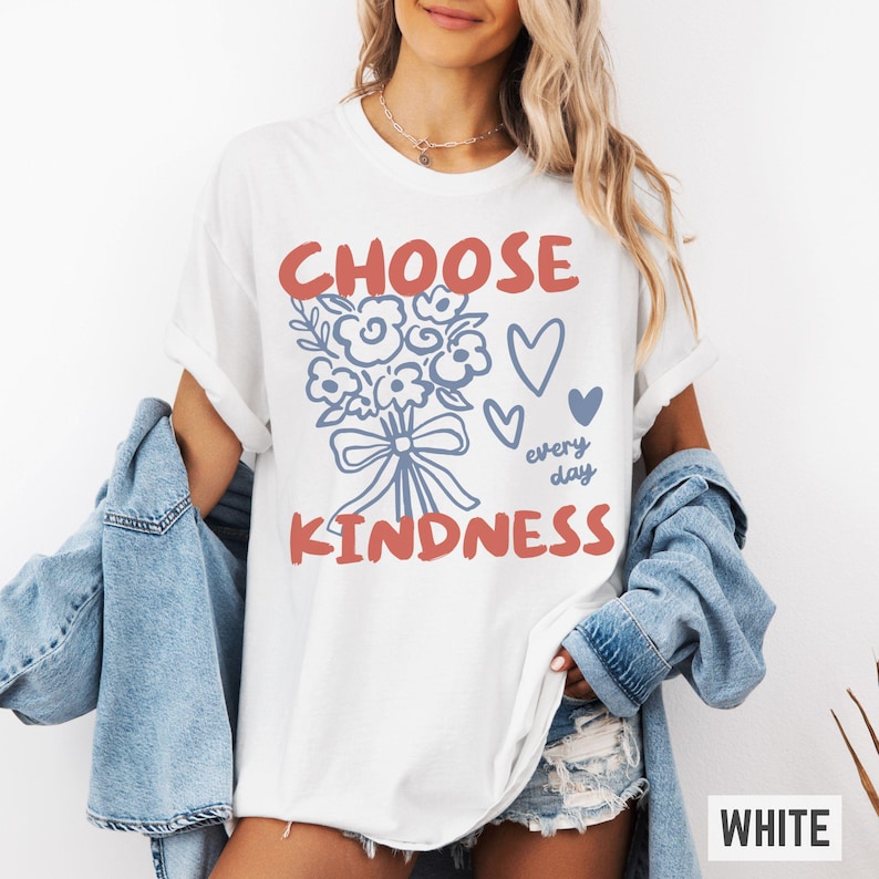 Comfort colors 1717 shirt that says Choose Kindness in large bold hand written font and has doodle images of a bouquet of flowers with a bow and hearts and the words every day written smaller in doodle cursive.