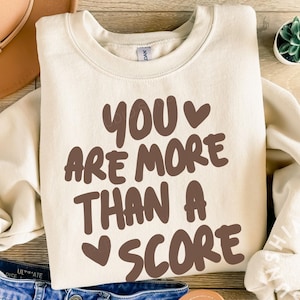 May include: A set of three ceramic mugs with a speckled, matte finish. Each mug features a different color: light blue, cream, and gray. The mugs have a simple, modern design and a comfortable handle.