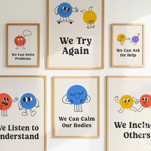 May include: A collection of framed art prints with a positive message. Each print features a cartoon character and a phrase like "We Can Solve Problems" or "We Try Again." The prints are in wooden frames and are displayed on a white wall.