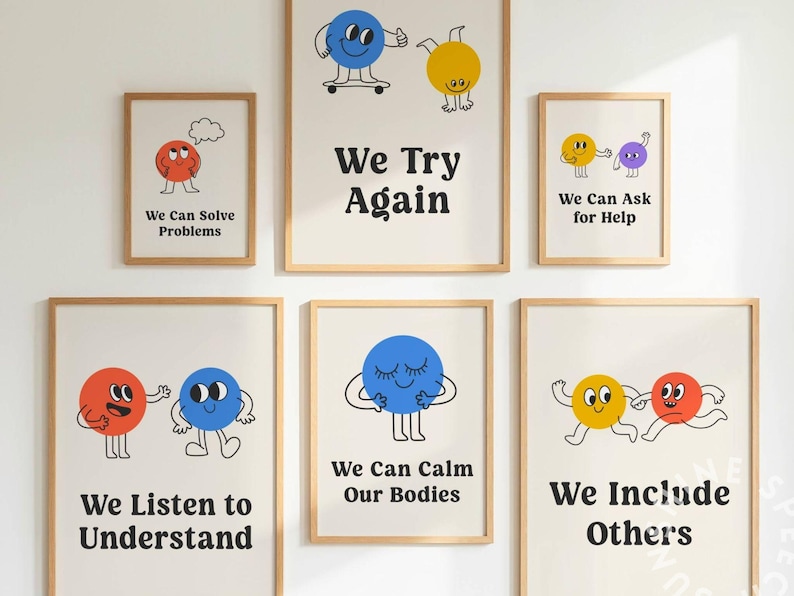 May include: A collection of framed art prints with a positive message. Each print features a cartoon character and a phrase like "We Can Solve Problems" or "We Try Again." The prints are in wooden frames and are displayed on a white wall.