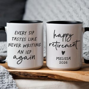 May include: Two white ceramic mugs with black handles and rims. One mug reads "EVERY SIP TASTES LIKE NEVER WRITING AN IEP again." The other mug says "happy retirement" with a heart, name, and year.
