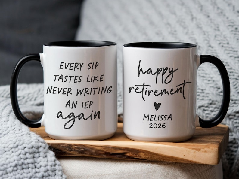 May include: Two white ceramic mugs with black handles and rims. One mug reads "EVERY SIP TASTES LIKE NEVER WRITING AN IEP again." The other mug says "happy retirement" with a heart, name, and year.
